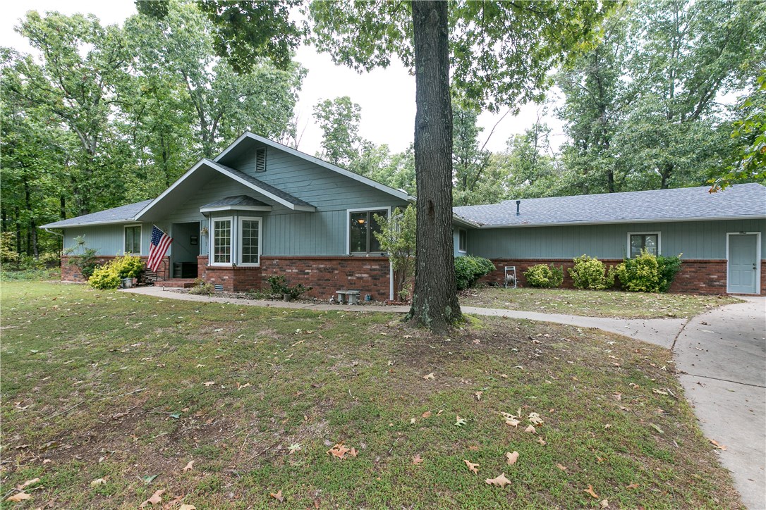 Beautiful home on large lot in Bella Vista. Features include 4BD/2.5BA, large kitchen and living room, wood burning fireplace insert that heats up to 2,000 sqft, wood floors, laundry room, lots of cabinets in kitchen, dining area. Master bath has double vanity and separate tub and shower. HVAC unit new in 2015. Walk out to the large secluded backyard with covered deck and storage shed. This house will not last long!
