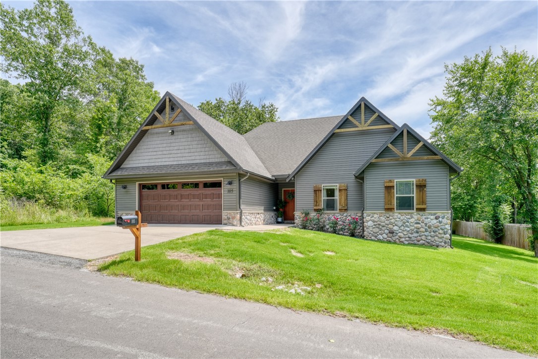 Adorable Modern Rustic Retreat in the Heart of Bella Vista! This charming home has 3 beds, 2 baths, an office, & bonus room. It blends cozy comfort with modern updates and rustic character. You'll love the stone & cedar details throughout. Sitting on a rare, flat lot, it features a spacious open-floor plan, gorgeous eat-in kitchen perfect for gathering, & a large living room with a stunning stone fireplace. Natural light flows in through the large windows bringing the outside in. Relax on the covered back porch overlooking your large backyard, garden, & play set. Enjoy access to Bella Vista’s world-class amenities, including lakes, golf courses, fitness centers, community centers, pools, tennis courts, an archery range, tennis, & pickleball. With mountain biking trails just around the corner and only 15 minutes to downtown Bentonville, you’ll be perfectly positioned for both adventure and convenience. Please note that the range pictured does not convey. It will be replaced with a similar stainless steel range.