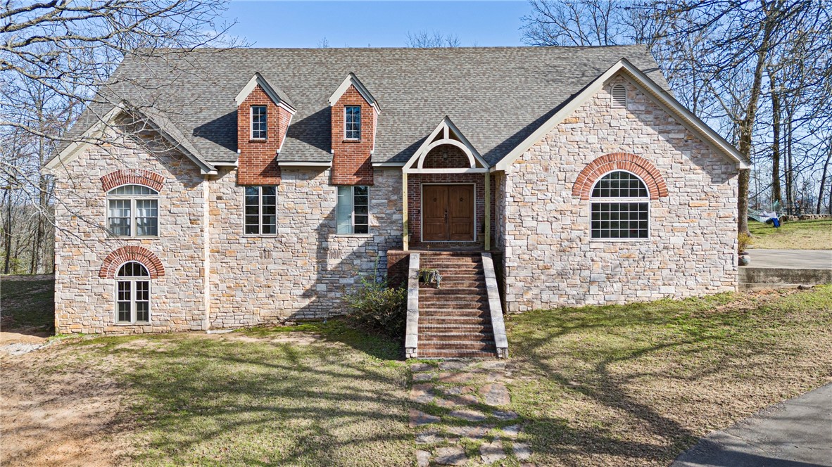 Back on the Market—No Fault of the Seller! Seller is motivated!! Now listed below appraised value, this breathtaking custom-built 4 bedroom and 4 bathroom home offers privacy and convenience, just one mile from the freeway and restaurants. This home is designed for comfort and style and has an open floor plan with a walk-out basement. Soaring 14’ ceilings in the living room, 12’ in the kitchen/dining, and 10’ throughout create an airy feel. The primary suite (12’x22’) boasts a fireplace, wall of windows, and His & Her walk-in closets. The walk-out basement includes a den/game room, bedroom, and full bath. Enjoy quartz countertops, custom cabinetry, a huge pantry, and crown molding throughout. Extra insulation (2x6 walls) keeps energy costs low. The 12’x24’ deck offers stunning wooded views—like living in a treehouse!