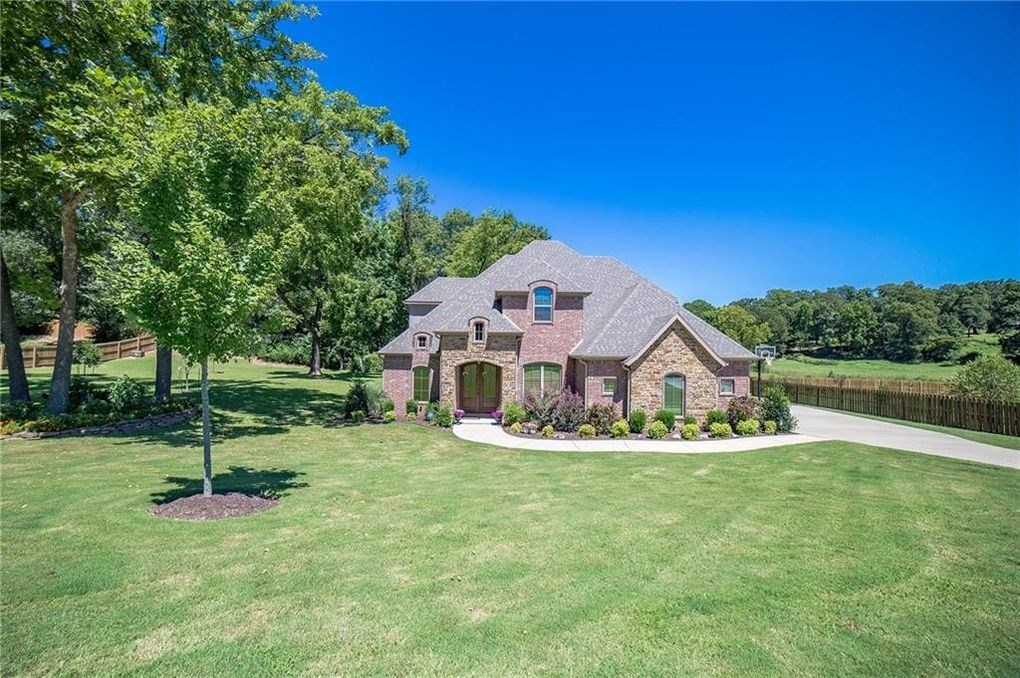 : FAMILY DREAM HOME, with room to play on extra-large corner lot. Located in a great neighborhood, this country setting is close to some of the best schools in Bentonville. The .73/acre beautifully landscaped lot backs up to a small private farm with horses. Gorgeous entry, beautiful hardwood floors, and open floor plan. Master suite is located on main floor, along with formal dining room, office, living room and stunning kitchen with granite counters and many extras. Upstairs has 3 bedrooms with 2 baths and a bonus room. With a three-car garage and generator, this meticulously maintained home has it all!