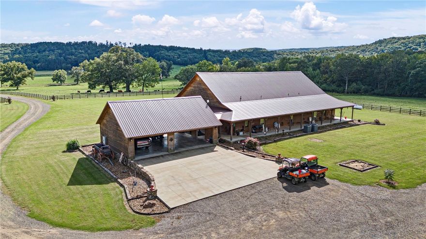 Amazing farm with large 4930 foot custom built 4 year old home with approx 8738 feet under roof! This amazing home offers a genuine farmhouse feel with whole house wrap around porches, spacious garages, and lots of natural wood decor! This is a showplace cattle ranch with new fencing, 2- 40x80 barns and 1 60x90 newer red iron hay barn. There is also a 50x60 working pen, a 90 acre bermuda hay field, a 20 acre row crop corn field. This farm has approx 50 acres in woods and the remaining 327 acres in pasture. There is also a 14x40 1 bdrm 1 bath dwelling.