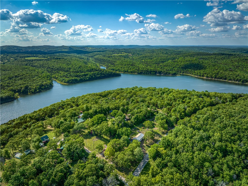 Enjoy the peaceful charm of this 2-bedroom, 2-bath home with 1,120 sq ft of comfortable living space. Just minutes from Tucker Hollow, this property offers easy access to the lake and all the outdoor recreation it provides. The open floor plan and warm, cabin-like feel make it a perfect retreat after a day on the water. With its inviting layout and prime location, this home offers excellent potential as a vacation property or nightly rental. Located approximately 20 minutes from the Lead Hill golf course, it's an ideal spot for those who enjoy both fishing and fairways.