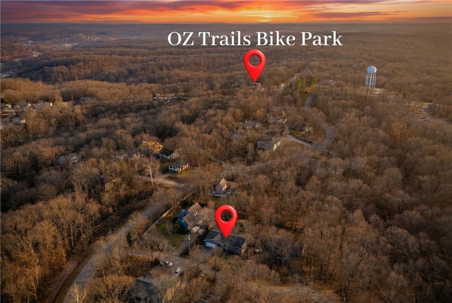 Less than one mile from OZ Trail Bike Park, this home is the ideal location for mountain bikers, short-term rental investors, or anyone looking to purchase a home in a convenient location here in Bella Vista. Not only located near the top of the OZ Trail lift, but also less than a mile to Hwy 71. This homes large sunroom fills the space with natural light. The sunroom overlooks the flat backyard and wooded area behind the property. All bedrooms have large walk-in closets. The garage is oversized, large enough to fit your fishing boat or a workshop space. The garage also has a side door that leads out to the backyard. Each room of this home is spacious, including your laundry room and the unfinished basement which provides 340 square feet of storage. When winter rolls back around the wood burning stove (hard to find this feature) will keep you warm. Come enjoy your morning coffee in the sunroom before you head out to OZ Trails for a day of fun!