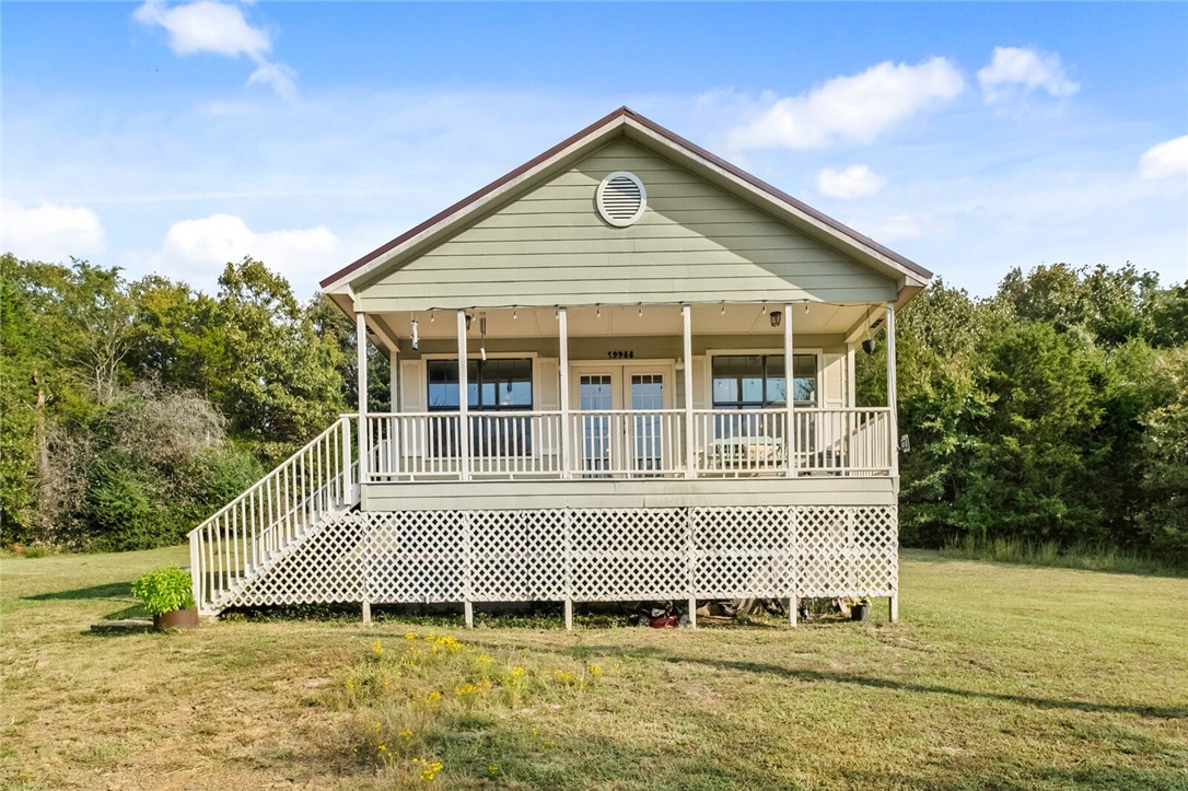 Welcome to 19988 Pug Gayer Rd, a charming 1,144 square foot home on 6 acres. Enjoy your mornings on the large porch overlooking beautiful hardwood trees. Step inside to a sun filled home with an open floor plan, 2 bedrooms, 2 bathrooms, & a laundry room. The primary bathroom provides a place to retreat and recharge with a large jetted soaker tub and a relaxing moody color scheme. This home features LVP flooring, fresh paint, stainless steel appliances, a new dishwasher, and new light fixtures. Zoned for Vandergriff Elementary, just a 15 minute drive away. Home is also 9 minutes away from the Blue Springs Boat ramp at Beaver Lake for the fishing enthusiasts. This is country living at its best just a short drive to restaurants and shopping. Come check out your future home!