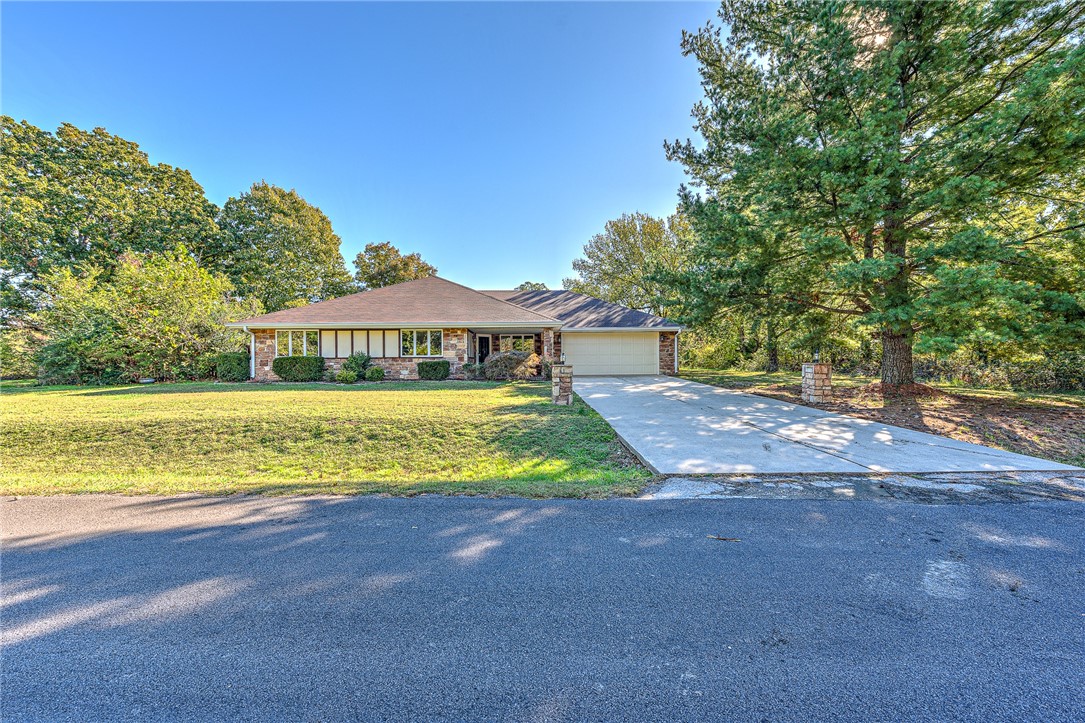 Beautiful 3/2 home with easy access to I-49, Loch Lomond, Highlands Golf and Pub, Branchwood Recreation Center and the Highlands Gun Range. This home has a large living area with a wood burning fireplace, access to the back covered 30x10 patio as well as from the kitchen area. Also, a covered front porch. Level yard with privacy fence in the back. The garage has a pulldown stair access and an outside door. The roof was replaced in the spring of 2019. Electric Lennox HVAC with propane combo heat, 2017. Certified with 2-10 Home Warrant for one year. New microwave 10/23. Take a walk around the block and enjoy the views of Loch Lomond Lake.