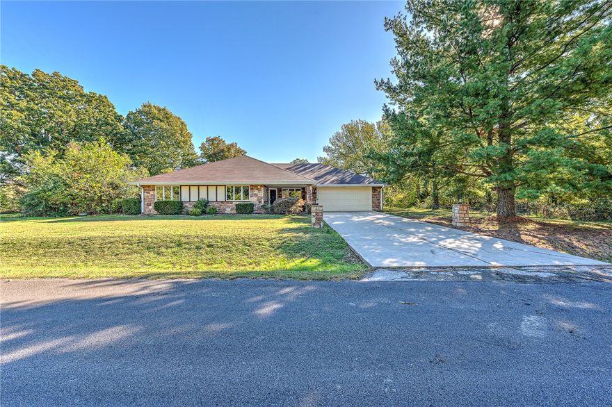 Beautiful 3/2 home with easy access to I-49, Loch Lomond, Highlands Golf and Pub, Branchwood Recreation Center and the Highlands Gun Range. This home has a large living area with a wood burning fireplace, access to the back covered 30x10 patio as well as from the kitchen area. Also, a covered front porch. Level yard with privacy fence in the back. The garage has a pulldown stair access and an outside door. The roof was replaced in the spring of 2019. Electric Lennox HVAC with propane combo heat, 2017. Certified with 2-10 Home Warrant for one year. New microwave 10/23. Take a walk around the block and enjoy the views of Loch Lomond Lake.