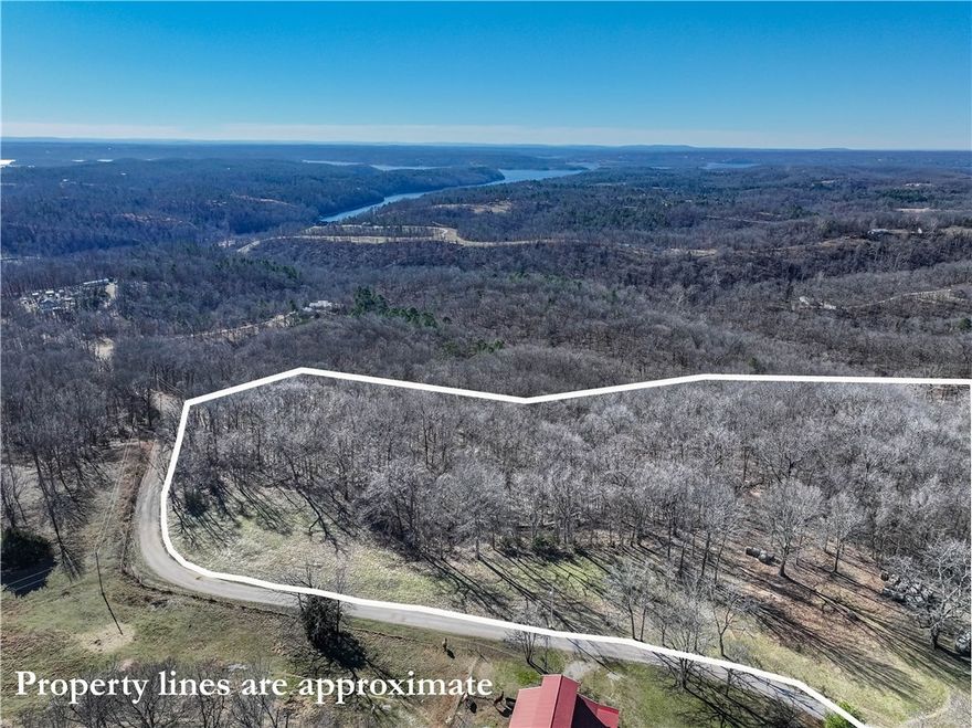Enjoy the best of both worlds with this 10.1 acres of Ozark Beauty! The Serenity of country living with all the wildlife and yet only 15-20 minute drive to downtown Rogers, AR. and all the city offers. This property lays perfectly for a single level home or a multi-level with walk out basement design. The land has a nice mix of clearing and hardwoods. It also has a very gentle slope for the area. With selective clearing, the property can have amazing long year-round southern views of the Ozark mountains with Beaver Lake glistening in the valleys. The property has electric and phone utilities at the street. This parcel is a part of Lost Bridge Village community and as such, affords the owner the use of Lost Bridge Village amenities. These amenities can be found on the Lost Bridge Village website at: www.LBVCA.com. A few of the amenities include the Pickleball/Tennis courts, Community Swimming Pool, and Recreation Halls. Don't miss this opportunity to make the Beautiful Ozarks Mtns the location for your next home.