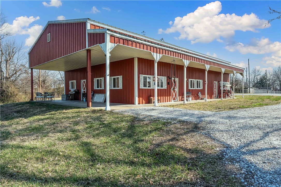Tucked away in the peaceful countryside of Gravette, Arkansas, this stunning barndominium is a perfect blend of rustic charm and modern convenience. Two bedrooms and four well-appointed bathrooms ensure there’s plenty of space for family and guests.
Inside the open-concept living area highlights the exposed wood beams and custom barn doors. The expansive primary suite, a true retreat features a private sauna, dual walk-in closets, and an en-suite bath with double vanities and an oversized walk-in shower.
A massive 50x60 shop, built in 2020 is fully equipped with plumbing, a septic system, a 50-amp RV hookup, and steel line drops for air compressors. A separate entrance leads to a dedicated office area. The shop also includes a utility room with a half bath, washer and dryer connections, a roll-up door, and an attic for additional storage.
Whether you're looking for a family home or a place to simply enjoy the beauty of nature, this exceptional barndominium is ready to welcome you home.