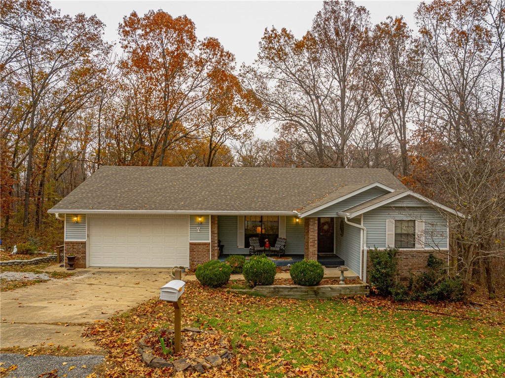 This well-maintained 2-bedroom, 2-bathroom home with 2 lots (.52 acres) offers a perfect blend of comfort and functionality. The spacious living room features a brick fireplace with a new gas log insert and remote, ideal for cozy evenings. Hardwood floors flow through the kitchen, dining room, and living room, adding warmth and style. Enjoy year-round relaxation in the heated and cooled sunroom or unwind on the screened porch. The 256 sq ft golf cart garage/workshop with concrete flooring is perfect for hobbies or storage. Updated finishes throughout. Whether you're entertaining or relaxing, this home has it all—comfort, charm, and versatility. Don't miss out on this move-in-ready gem!