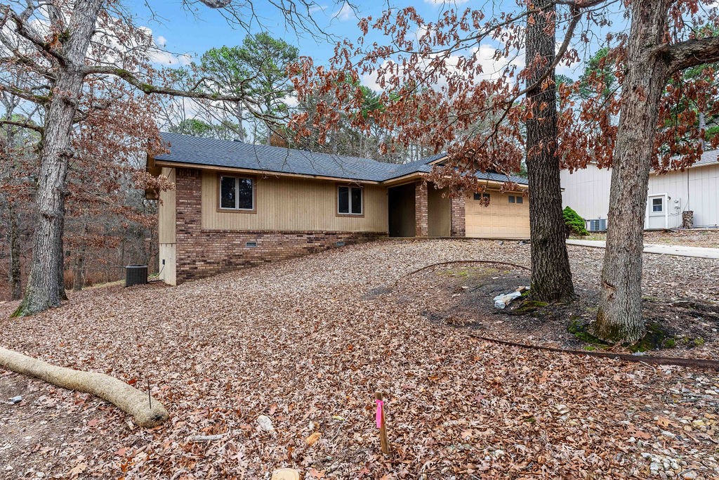 Potential abounds with this Bella Vista home located just up the road from the Back 40 Buckingham Trailhead. The Back 40 trail system runs behind the small cul-de-sac where the property is located, making this the perfect home for bikers, a Bella Vista getaway or even a short-term rental. 3 bedrooms, 2 baths with an open living/kitchen concept. Wood-burning fireplace in the living room and 2-car garage. The home has a great layout with an effective use of space, which feels larger than the 1323 sq ft on record. New roof in 2024. Bentonville Schools. With a little updating, this one can be just what you have been waiting for!