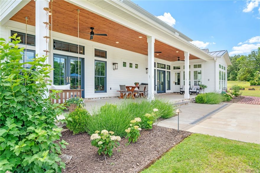 This private retreat offers 130 acres of breathtaking natural beauty just under 10 miles from Dickson Street. With stunning views of the Boston Mountains, rocky bluffs, mature trees, and a spring-fed, stocked one-acre pond with a dock, this property is a rare find. Abundant wildlife, including deer and turkeys, roam freely, and 100-year-old white oaks add to its charm. The custom home is designed with high-end finishes, including Kallista faucets, unlacquered brass hardware, zellige tile, and marble countertops. A wet-weather creek is part of the acreage, enhancing its natural appeal. The 30x60 outbuilding provides storage or workshop space. The insulated garage is designed to accommodate a future second-floor apartment. The raised bed garden and apple orchard an opportunity for homegrown produce. The property features a pickleball court and basketball court for recreation, and there is an option for a second home site, already prepared with a water tap, septic test, Ozarks Electric access, and a cleared driveway.