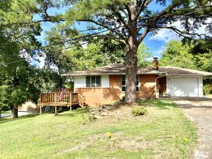 This home has something for everyone! You will love the beautiful updated kitchen, cozy fireplace, hardwood floors and deck that over looks the large corner lot. The brick home has an attached garage along with a 20 x 20 detached shop and a walkout basement perfect for storage or additional living space!