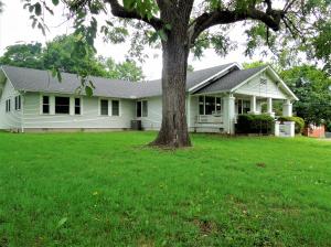 This beautiful turn of the century home is a must see. It sits on a large lot with mature shade trees and shrubs. The covered front porch is a perfect spot to relax with friends. Inside, it features original hardwood flooring, wide trim, and all the charm that you'd expect in a home from this era. It's exceptionally well maintained, and has central heat and air, spacious rooms, gas fireplace , 2 full baths and 4 (could be 5) bedrooms. The master suite has a walk in closet and attached bath. Large laundry room and large kitchen, as well as a formal dining room. There's also a detached 2 car garage. Immaculate and move in ready!Room sizes approx., sq ftg per assessors office.
