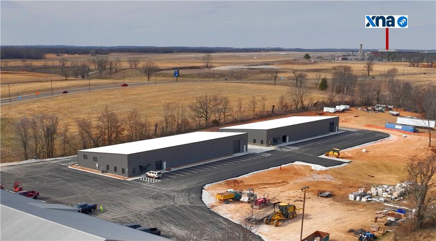 Position your business for success in these two brand-new warehouse/flex buildings that are +/- 12,000 SF each and ideally located just off Highway 264, directly in front of XNA. The first building (suite 1900) already has an office space built out featuring three private offices, two restrooms, a kitchen/break area, mop closet, and dedicated storage closet, providing a functional and professional environment for your team. A custom office build out can be complete in the second building with a 4-week turnaround. The warehouses offer excellent accessibility and operational efficiency with four drive-in doors (two on each building) plus access to a shared loading bay with one dock high door on each building, ideal for distribution, light manufacturing, or flex users. Strategically positioned just 8.5 miles to the I-49 interchange, approx. 20 minutes to J.B. Hunt HQ, and approx. 25 minutes to Walmart's New HQ Campus. This property is an exceptional opportunity for logistics, service, or growth-oriented businesses.