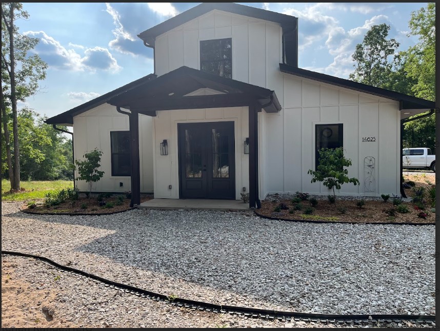 Must see barn style farm house set on a beautiful 4.23 acre wooded lot. The house boasts a spacious open floor plan with tongue and groove ceiling, beautiful gas fireplace, dining room and a kitchen that any cook would fall in love with. Kitchen has a large walk in pantry. A nine foot custom island constructed from a 150 year old barn made of solid white oak. The primary bedroom has a large primary bathroom with a custom shower. The walk in closet features a built-in dresser. Nice guest room with custom closet for extra storage. Second bathroom has a tiled shower/tub combo and vintage vanity. This home also features a large mud bench with custom cabinetry, an office/craft room with custom built in cabinetry. Oversized garage able to fit large pickup trucks. There is also a large workshop with a half bathroom as part of the home's floor plan. To top this off, this home features an additional 900 sq feet upstairs that has wiring and plumbing for future use. Donāt let this amazing home get away.