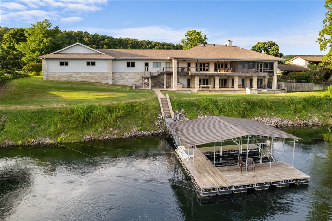 Exquisite riverfront residence located within the prestigious Airport community. This meticulously crafted home features 3 Bedrooms and 3.5Baths, showcasing a wealth of high-end updates including crown moldings & 3/4-inch hardwood flooring. The chefās kitchen is a culinary delight, custom maple cabinetry, solid surface countertops, butlerās pantry. The expansive master suite offers a luxurious en-suite bathroom, a cozy sitting area w a fireplace, a walk-in closet, and a private lanai complete with a hot tub area. The lower level is designed for family gatherings, featuring kitchen, LR with a fireplace, game room, wine cellar, bedroom, and a safe room. With a stunning real stone exterior complemented by low-maintenance concrete siding, this home is built to last. The outdoor space is exceptional, featuring a large covered tiled concrete patio that offers breathtaking views of the river & access to your private boat dock. Additionally, a two-car garage and a 43āx35ā airplane hangar.