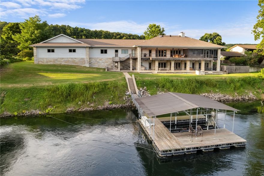 Exquisite riverfront residence located within the prestigious Airport community. This meticulously crafted home features 3 Bedrooms and 3.5Baths, showcasing a wealth of high-end updates including crown moldings & 3/4-inch hardwood flooring. The chef’s kitchen is a culinary delight, custom maple cabinetry, solid surface countertops, butler’s pantry. The expansive master suite offers a luxurious en-suite bathroom, a cozy sitting area w a fireplace, a walk-in closet, and a private lanai complete with a hot tub area. The lower level is designed for family gatherings, featuring kitchen, LR with a fireplace, game room, wine cellar, bedroom, and a safe room. With a stunning real stone exterior complemented by low-maintenance concrete siding, this home is built to last. The outdoor space is exceptional, featuring a large covered tiled concrete patio that offers breathtaking views of the river & access to your private boat dock. Additionally, a two-car garage and a 43’x35’ airplane hangar.