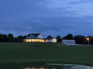 Pending accepting back up offers. This beautiful 6 BR 4 & 1/2 BA farmhouse on 36 manicured acres deserves your attention! 3 levels offer living room with gas log fireplace on main floor, huge family room with kitchenette in basement, and loft with room to gather and socialize upstairs. MBR on main floor with another MBR upstairs. Kitchenette in walkout basement provides for the option of separate living quarters. Wrap around porch with breezeway to 2 car garage. 30' X 40' Shop building with electric, water and bath. Pretty acreage with views is mostly open with 3 ponds. Property fronts a county road and is minutes from Harrison and approx. 45 minutes to Branson, MO, Bull Shoals and Table Rock Lakes, and White River. 25 minutes to Buffalo National River.