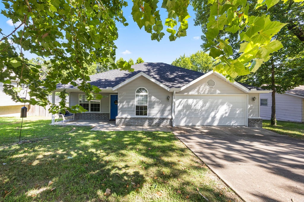 This home is as cute as a bug, with a big front porch to enjoy the peaceful surroundings. All on one level, this 3-bedroom, 2-bath home has been well-maintained & loved. You will be thrilled with the spacious eat-in kitchen for entertaining guests, which connects to the very roomy living room. The front bedroom is currently being used as an office and is conveniently joined to the guest bath. The primary suite has plenty of room to move with a private en-suite. Also overlooking your private backyard. You will love your new deck made out of all composite material. Other updates include a new roof and gutters, bathroom fixtures, and all new blinds throughout the home. You will be sure to enjoy the whole house smart touch light switches with night lights. The oversized garage has plenty of storage and room for a workshop area. This home is in a wonderful location with easy access to I-49 and the Bella Vista Bypass. Plus only minutes away from the "uphill both ways" bike trail. This home is a must-see!