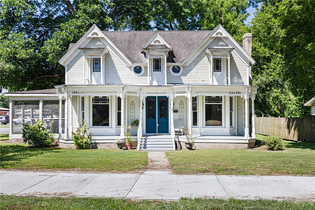This Victorian Gothic treasure is proudly listed on the National Register of Historic Places. Its intricate Carpenter Gothic trim, weatherboard siding, and cross-gabled roof create a striking first impression. A large covered front porch welcomes you to slow down and enjoy the charm of historic Dardanelle. Inside, original hardwood floors have been beautifully preserved. The kitchen features custom cabinetry, stainless steel appliances, and butcher block countertops. The bathroom has been thoughtfully updated with heated tile floors, a walk-in shower, and the original clawfoot tub. Behind the home sits a 1,200 sq ft red iron shop with two bay doors—perfect for parking, storage, or a business venture in this prime location near other local businesses. Upstairs balconies offer stunning Arkansas River views. Out front, Dardanelle’s brand-new trail system stretches down Front Street and connects to Merritt Park—offering a scenic walk or ride through town and along the riverfront.