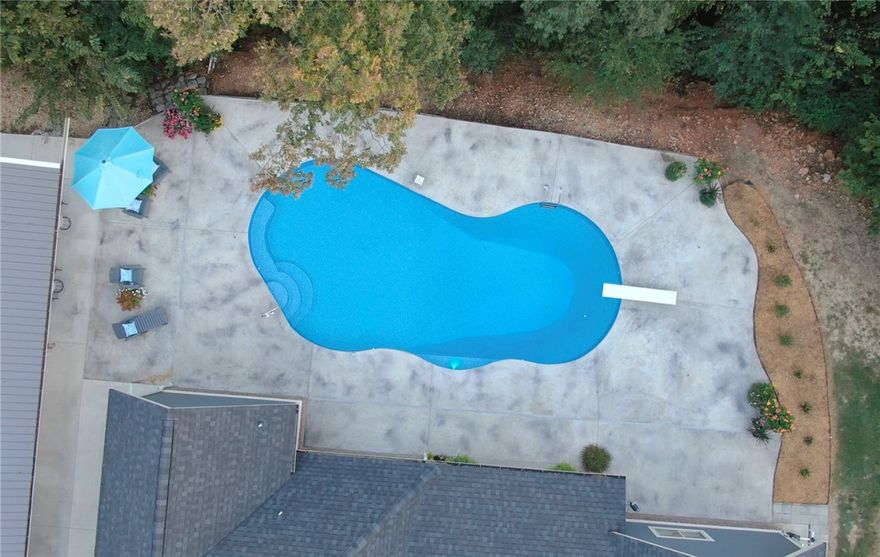 This is it! The property everyone has been waiting for nestled in the Ozarks on over 10 acres.  Main home is 3640 sq ft and offers Split floorplan with 4 large bedrooms with 4 walk in closets on the main level and a large bonus room and office nook upstairs.  2020 addition of a guest house that is currently being used as a man cave. Would make a nice mother-in-law home or could be an income property. Guest house has a state of the art kitchen and totals 1248 SF. Underground storm shelter in the oversized garage. Gorgeous heated pool with a lighted deep end and diving board built in 2021. Auto irrigation in all beds. Pellet stove in house. Custom window treatments convey throughout. 2 septic on property, one for main and one for the guest home. Equipment shed workshop 4 stall unit has electrical, night time lighted. Propane tank owned. Beautiful custom home nestled back in a park-like setting on over 10 acres. 2 zoned air conditioner keeps all areas the perfect temperature. Close to trails and Siloam City Lake.