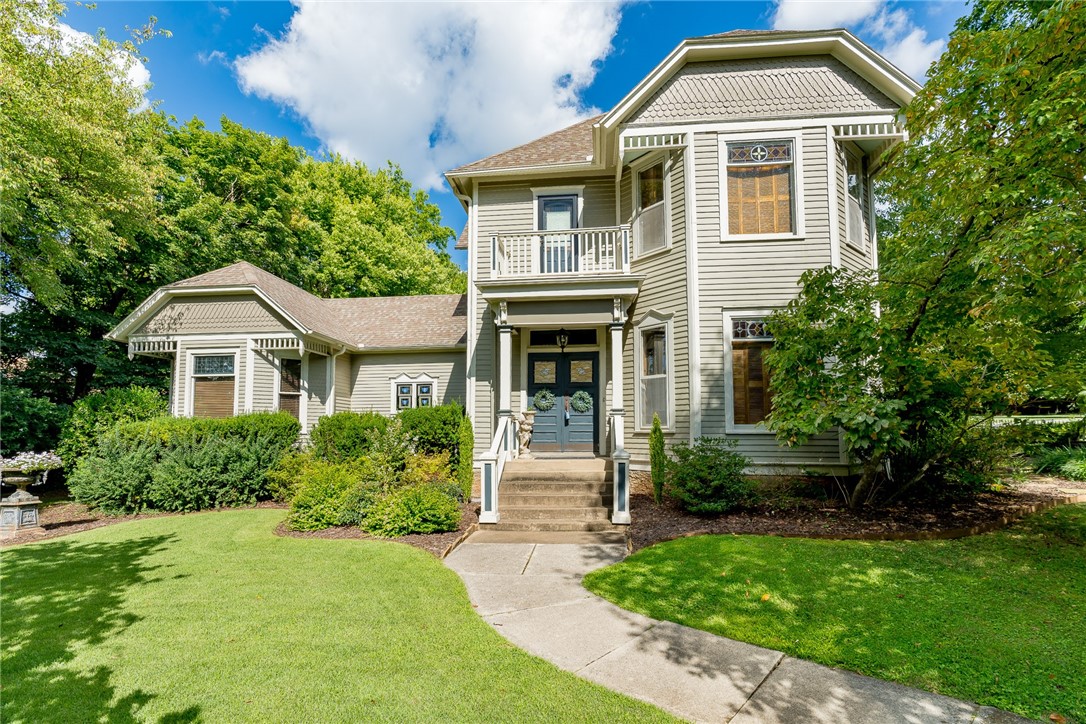 This Eastlake Victorian home is surrounded by serene gardens on a large lot in the Fayetteville Historic District. The home is within walking distance to the Fayetteville Square, Ozark Natural Foods and much more. The 4br/3.5b home is fully updated while keeping its historic charm. Multiple areas for entertaining and dining inside and out. The main level master bedroom features a private sitting room, plantation shutters and a backyard exit to the gardens. Kitchen features wine fridge, wet bar with ice maker, and a large pantry. The home has been modified to be energy efficient.
