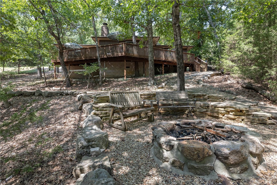Experience serene lakefront living with this fully furnished, one level, 3 bedroom, 3 full bath home. The open floor concept makes the kitchen, living room, and dining area seamless, along with a bonus room, currently used as 4th bedroom. The outdoor area boasts a large deck for entertaining that overlooks a fire pit for relaxing evenings along with a gentle slope to the water. Currently used as a weekend getaway and cash flowing short term rental. Home purchase also includes a 26' transferable boat slip lease at Lost Bridge Marina. Selling "as is". Proof of funds or pre qual letter required with offer.