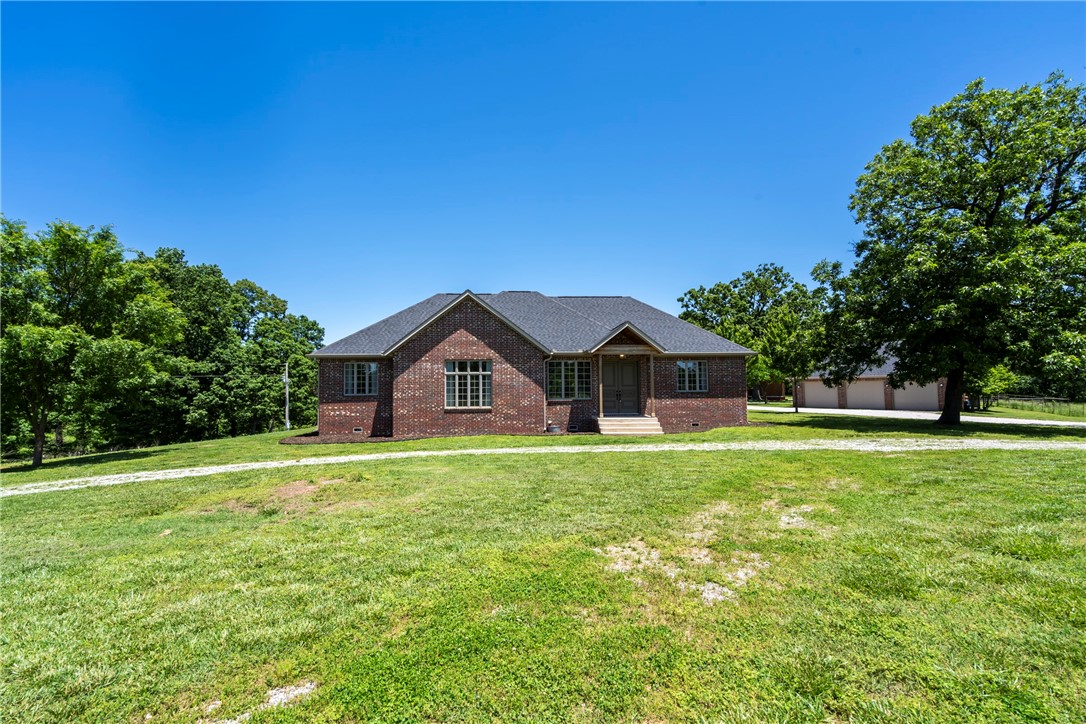 Beautiful home with gourmet kitchen, hardwood floors and high ceilings! Home is set off the road on a small 10+ acre ranch, perfect for horses or cattle. Private and quiet setting in the country. Perfect get away from the hustle of the city but a super short drive to get on the interstate, which makes you close to everything. Property has a large very nice pole barn for implements and farm related items, also has fencing and a corral. The three car garage is close to the house for ease of parking. Also has another outbuilding for storage. If you’re looking for a modern home in a quiet country setting, this is the perfect location for you!