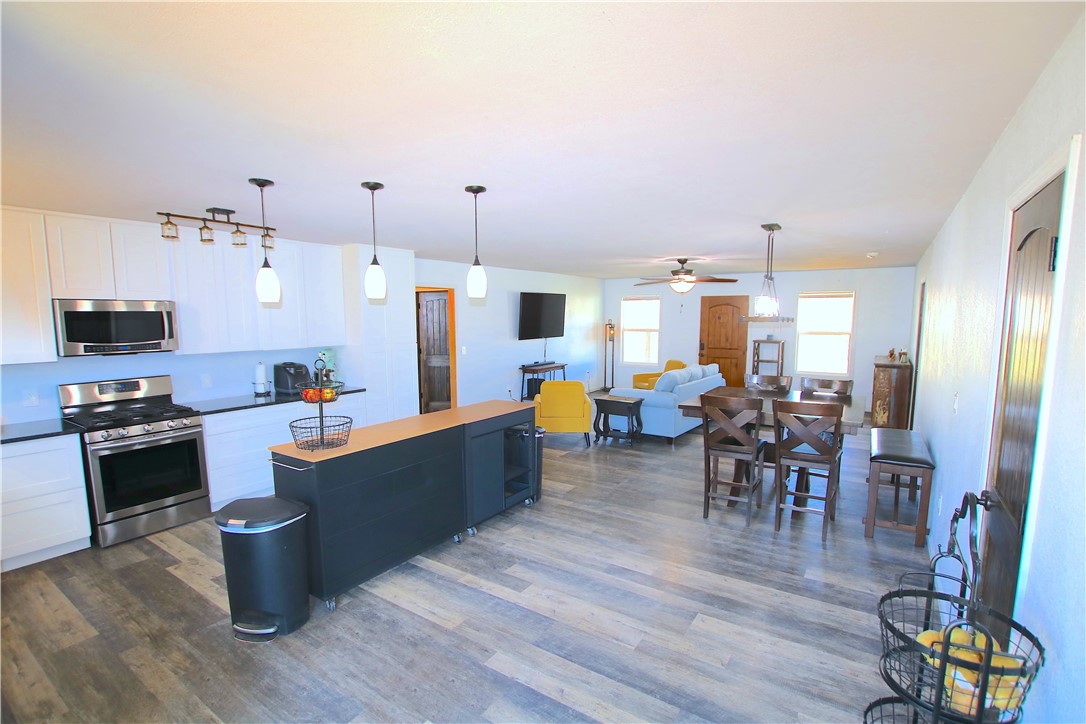 This 4-bedroom, 3.5-bathroom residence is nestled on 1.2 acres in the vibrant heart of Rogers,
providing a blend of privacy and space in a rapidly developing area. The first floor boasts a
generous open-concept kitchen and living area, along with three bedrooms, each featuring its
own bathroom. The master bath is a standout, showcasing a stunning tile walk-in shower and
a spacious standalone bathtub. Upstairs, you'll find an additional living area and a large
bedroom, with a bathroom that includes a convenient "wet space" where the walk-in shower
and bathtub are combined. The backyard offers a serene environment with ample space for
constructing an extra shop. Located directly across the street from Lost Springs Golf Club,
this property is in a continually evolving area. It presents numerous opportunities, including
potential rental income, and is conveniently situated just off Highway 12, making for a quick
drive to the new Walmart Home Office.