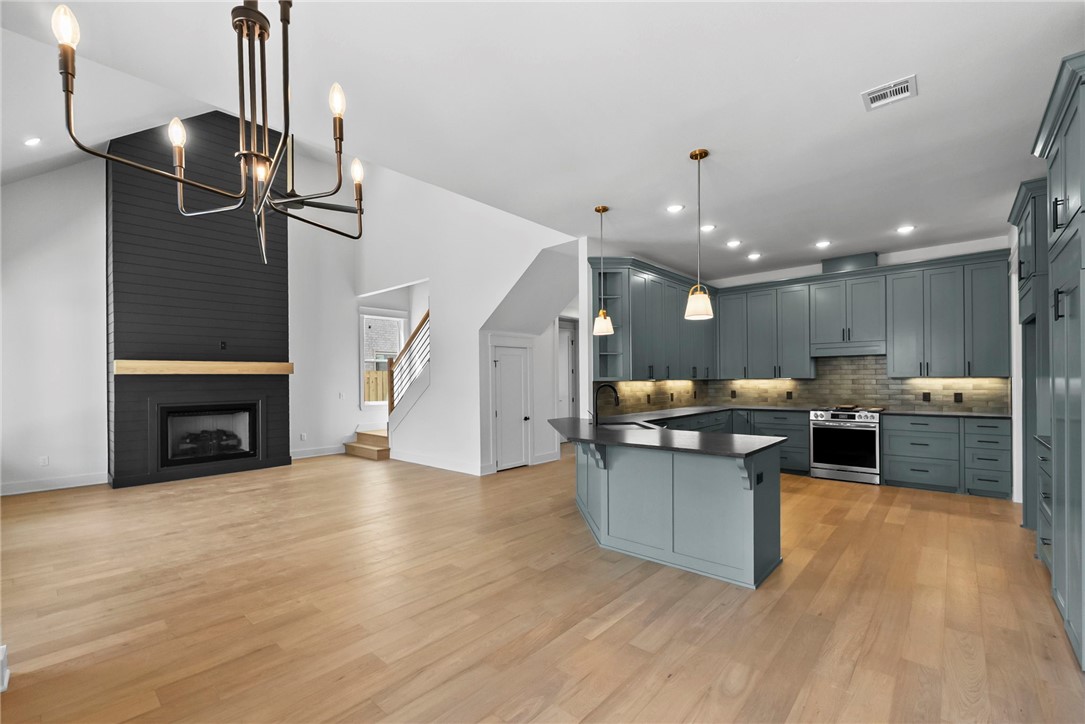$5,000 Builder Credit with acceptable offer! Experience the perfect blend of elegance and functionality in this stunning 4-bedroom, 4-bathroom home! This layout and the finishes throughout truly set this home apart! The primary suite and an additional bedroom with a full bath are conveniently located on the main floor. Upstairs features two more bedrooms, two bathrooms, and a game room ideal for recreation or entertaining, with easy attic access for practical storage. Premium finishes include granite countertops, custom cabinetry, hot water recirculation, and stainless steel appliances, all centered around a welcoming eat-in kitchen. Energy-efficient windows and spray foam insulation enhance comfort and efficiency. The open-concept layout exudes warmth and sophistication with curated lighting. Future Phase 2 amenities will feature a pond, walking trails, clubhouse, and pool. Conveniently located under 20 minutes from Downtown Bentonville and the new Walmart Home Office, and just 15 minutes from XNA!