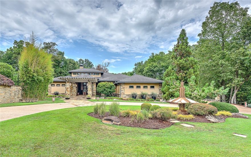 Don't miss this incredible Modern Ozark Prairie style home located in the gated golf community of Clear Creek. Custom design abounds beginning with the one of a kind lighted prairie style metal art piece adorning the front lawn to the beautiful stone entry way to the luxurious private in-ground salt water pool. This home does not disappoint with it's chef's kitchen featuring a Thermador gas range, built-in ice maker, trash compactor, double refrigerators and coffee bar. The spacious living and dining areas flow out onto the covered patio and pool area making this home perfect for entertaining. The large bonus/theater room downstairs is the perfect place to relax after a long day.  Enjoy working from home while watching the birds and wildlife from the floor to ceiling windows in your downstairs office/studio with heated travertine floor. Oversized three car garage. And, as an added bonus, the patio furniture conveys with the home! This home must be seen to be fully appreciated, so call today to make it your own!