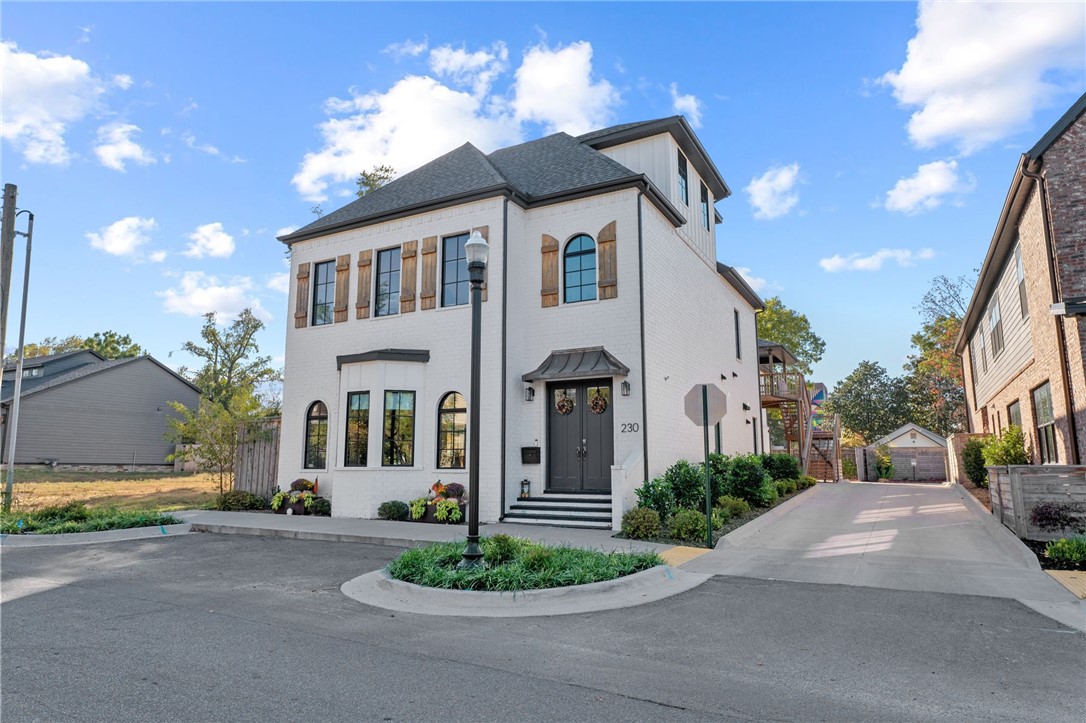 Multigenerational living or nanny's quarters in this gorgeous Brownstone located just 2 blocks from the renowned Bentonville Square and is surrounded by award-winning restaurants, mountain bike trails, and shopping. Rarely do these come available so now is your chance to live the Downtown Bentonville lifestyle. The main home offers 4 bedrooms, 3.5 baths, an office space, and a bonus space. In addition to the main is a separate residence at the back of the property with a private entrance. The ADU is a full 2 bedroom apartment fully equipped with kitchen, laundry, etc. The best part about this home is the oversized FOUR car garages plus additional parking in the back for your guests! This is unheard of for DT Bentonville. Schedule your showing today to see what makes this home so very special. Main home is 3718 sq ft and the guest quarters is 1263 sq ft.