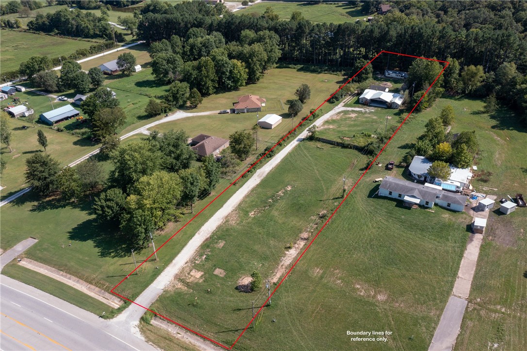 Do you need a place to call home just minutes away from Beaver Lake and Sonora Schools? Or a business that needs a location you can not beat? Come out east on HWY 412, and you will find an opportunity you don't want to miss. 1.9 acres with Hwy 412 frontage means easy access and entrance. Nice, flat lot with paved access. The home is on the very back of the lot and has so many potentials as well. A detached 780-square foot extra large garage behind the house. 1300-square foot pole barn with electrical. And just wait- there is more. A second utility address is already established and pumping electricity. Bring your imagination and dreams! There is no county zoning for this property, but any commercial use would have to be applied for to the City of Springdale Planning Dept first. Home is being sold AS IS
