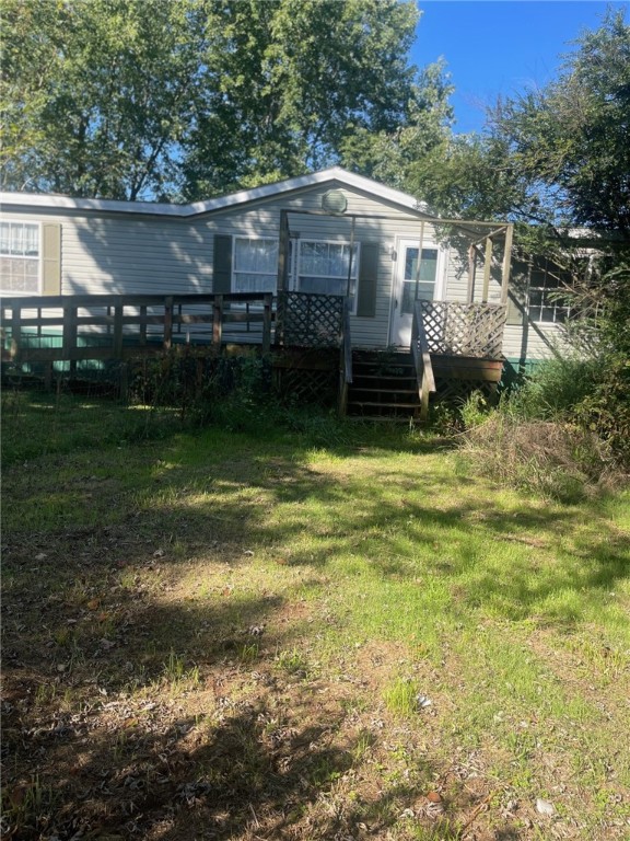 Fixer Upper on nearly 1.5 acres. Detached shop/garage. 4 bedroom and 2 bath modular home with lots of potential. Wood deck and screened in porch in the back. Wheelchair ramp in front.