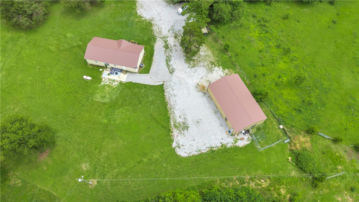Welcome to your dream country retreat! Nestled on 3.4 beautiful and level acres, this property offers peaceful rural living with the modern upgrades. Step inside to discover a spacious open floor plan featuring a generous living and dining area. The kitchen shines with brand-new cabinetry installed in 2023, complemented by sleek granite countertops. With 4 bedrooms and 2 full baths, there’s plenty of space for everyone. Major upgrades include a new HVAC system in 2025, a new roof in 2019, and new windows and siding added in 2023, giving the home a fresh, updated feel. Out back, you'll find a 50x30 shop built in 2023, complete with living quarters—including a kitchen, washer and dryer hook-up, and private space ideal for guests, extended family, or even rental income. Enjoy the quiet charm of country living with all the convenience and comfort you need—don’t miss this rare opportunity!