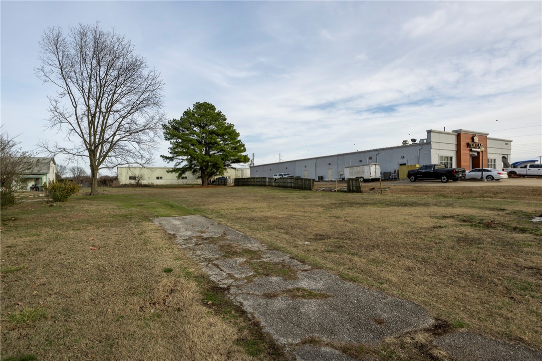 Expand Your Portfolio with Prime Commercial Opportunity! Strategically positioned near I-49, Downtown Rogers and Beaver Lake, this property is surrounded by major commercial growth, including Kum & Go, Storage World, and America’s CarMart corporate offices. Site consists of two adjoining lots, fully equipped with city utilities, offering a level, build-ready foundation ideal for commercial, retail, or multifamily development. The existing home is older and in need of updates but remodeled or redeveloped. Additionally, a detached building currently houses a studio apartment with tenants in place—do not disturb or access without representation. Located near Rogers Airport and key economic growth corridors, this property presents a rare investment opportunity with unlimited potential. Whether retail, office, mixed-use, or multifamily development, this prime location is ready to support the next phase of commercial expansion in Northwest Arkansas. Property is sold as-is, no repairs will be made. Also listed MLS#1299014