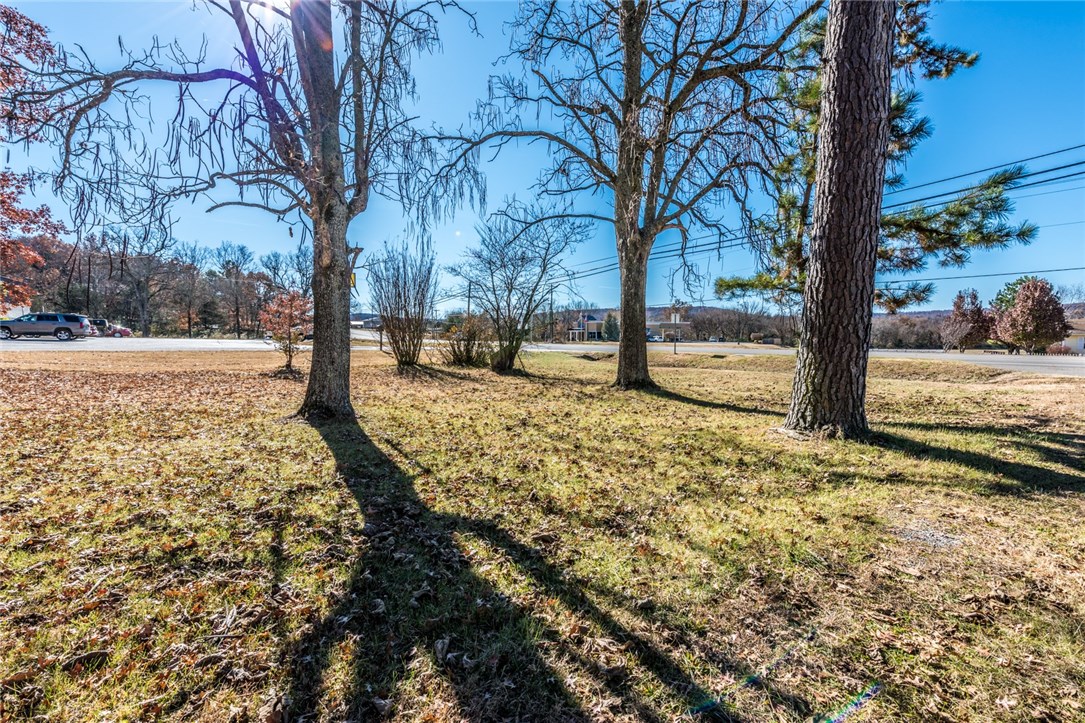 Don't miss your opportunity for this potential commercial location surrounded by nationally recognized commercial entities, this land has 165 ft of frontage on US Hwy 71 (AKA Centennial) and city utilities. Existing on lot is a 1312 sq. ft. 1 BR/1 BA wood siding home with bonus room is sold AS IS - no value.