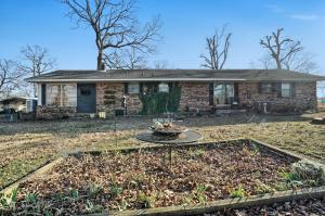 This is a HUGE home for a small price. The house itself is over 2500 sq feet with two living areas, two kitchens and a fireplace. It has just under 3 acres with a new storm cellar. The country setting offers solitude for the person who does not want to be in town. All this is available for 115K