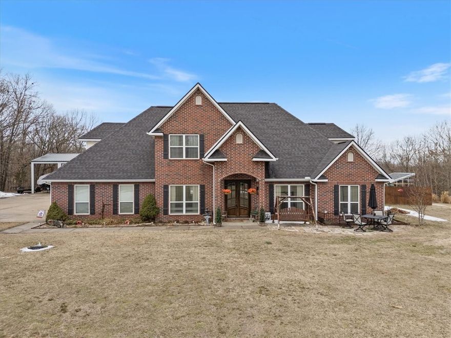 Set on 2.96 private acres,this 2,870 sq ft home offers comfort, functionality, and great outdoor living. It features 4 bedrooms, 3 full baths, a dedicated office, and a bonus room. The open living/dining area is the heart of the home, featuring an extended countertop bar and seating with views into the kitchen. A pellet stove creates a warm, inviting atmosphere.The primary suite includes two walk-in closets, a walk-in shower, twin sinks, and a soaking tub. Storage is plentiful, especially upstairs where a large attic storage room features a full-size walk-through door. Outdoor amenities include a covered back patio, brick paver sun deck, gazebo with brick wood-burning fireplace, hot tub, greenhouse, and a professionally maintained saltwater pool. A backyard playset adds family appeal. A perfect place for mechanics or car enthusiasts, the property includes a 2-car attached garage, 2-car carport, and a large concrete pad leading to a 4-bay workshop building with three oversized overhead doors and RV parking overhang.