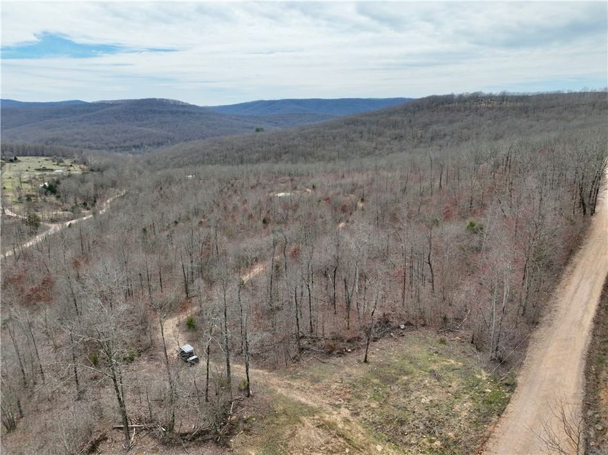 26.34 acres near Pettigrew, AR with county road access, pond, and trail system. Multiple build sites with views and nearby electric and rural water. Located near Ozark National Forest with hunting and recreational opportunities. Recently surveyed and suitable for residential or recreational use.