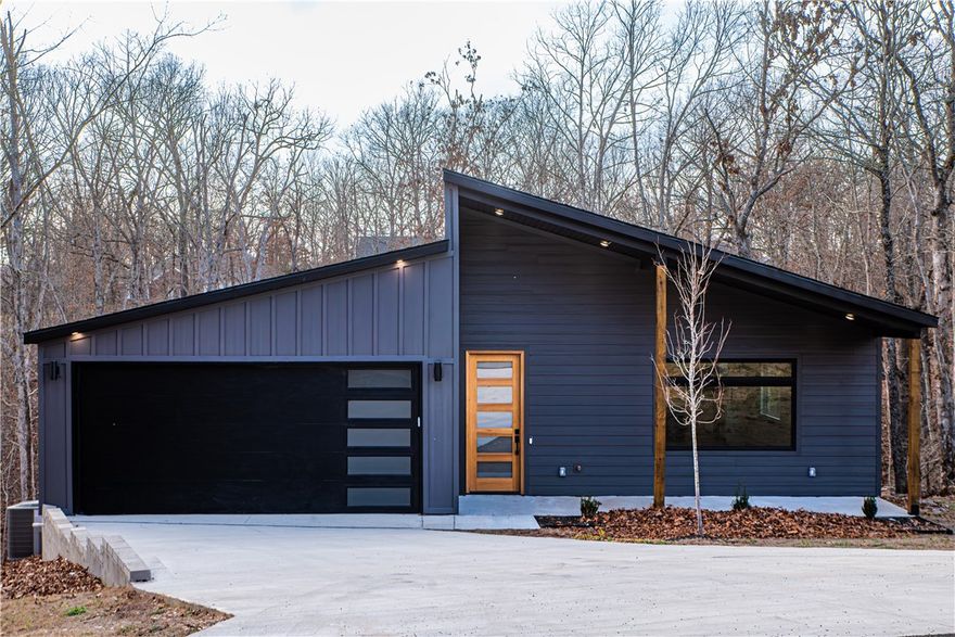 Welcome to your brand-new home in Bella Vista! This stunning 3 bedroom, 2 bath new construction offers 1,924 sq ft of modern design, quality craftsmanship, and a functional open layout. The kitchen is a showstopper with quartz counters and backsplash, stainless steel Café appliances, soft-close cabinetry extending to the ceiling, a spacious island, and a convenient coffee bar that flows seamlessly into the bright living area-perfect for entertaining. The spacious primary suite features a spa-like bathroom and walk-in closet, while two additional bedrooms provide comfort and flexibility for guests, family, or a home office. Enjoy peaceful Ozark surroundings from the covered deck with access to Bella Vista's lakes, trails, golf courses, and community amenities. Complete with a 2-car garage, energy-efficient features, and low-maintenance finishes, this move-in ready home is designed to impress. Don't miss the chance to own a brand-new home in one of Northwest Arkansas's most desirable communities! *Agent Owned*