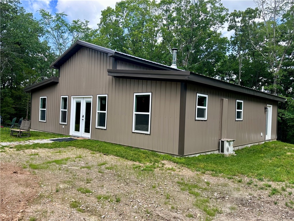Sellers need a contract in order to buy the home of their choice, therefore this listing is contingent upon that transaction. Custom brand new 2 bedroom- 2 bath - 1440 sf barndominium on 8.8 surveyed acres.
Circular white chat drive and a large custom built container barn that parks two cars under cover. Lush Garden and lots of room to expand on this level building site. Front porch never got built, but electrical in place for it's construction by new owner. Cedar post will remain as well as garden fencing. This place is neat as a pin and easy to see with an appointment. Home is move in ready and everything like new.
Shared well with written agreement with 3 other property owners. Well is on this property.