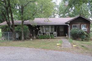 ONE OF A KIND FIND on Linker Mountain Rd with nearly 2 acres Features include spacious living room, large formal dining room or use it as a den/2nd living area, eat-in-kitchen, trap door in storage room off of kitchen that leads to the storm cellar,lots of character throughout 3 bedrooms 2 bathrooms, some wood flooring,large garage, storage shed, detached covering parking,deck just needs some TLC