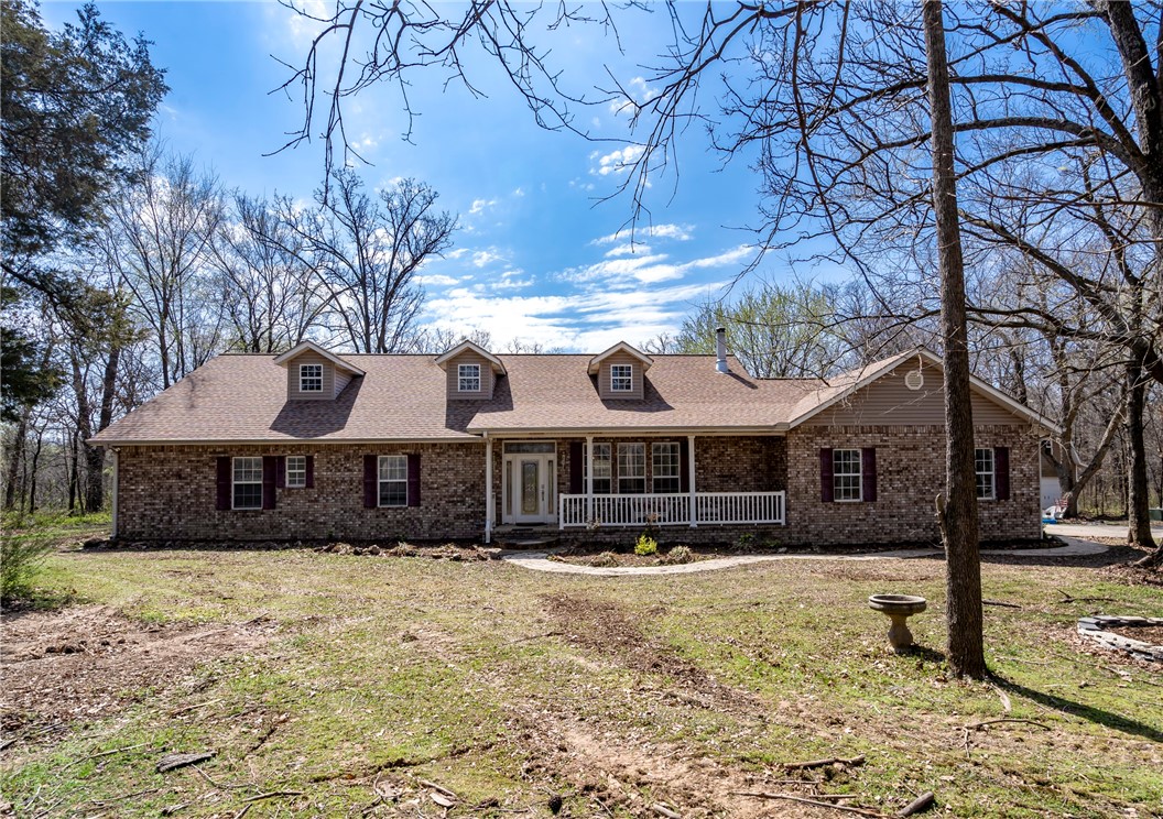Discover your dream home near the lake! This charming 3-bedroom, 2-bathroom home, built in 2006, boasts 2,247 sq ft of living space on a tranquil 2-acre lot. The kitchen is a chef's delight with elegant granite countertops. Surrounded by lush woods, this property offers privacy and natural beauty, all while being conveniently located just off the pavement. Enjoy rural water and the peace of this serene setting. Don't miss out on making this idyllic retreat your own!"