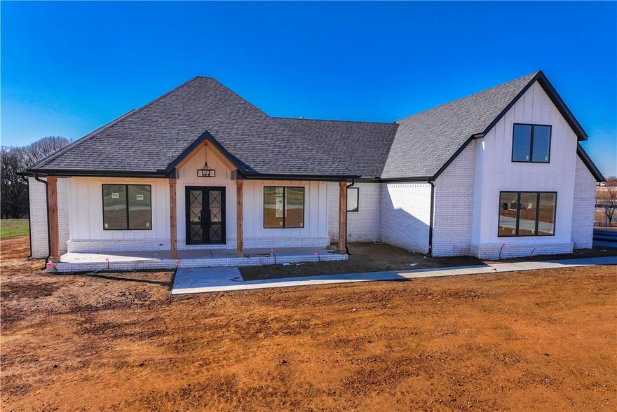 Discover this stunning new construction home on a sprawling 1.9-acre lot with breathtaking views and easy access to Tontitown’s vibrant amenities. Thoughtfully designed, it blends modern luxury with timeless charm. Inside, an open kitchen and living area feature stylish LVP flooring, ideal for both casual gatherings and formal dining. The master suite offers a tranquil escape with dual vanities, a spacious walk-in closet, a walk-in shower, and a soaking tub. With three additional bedrooms, an upstairs bonus room with bath, and a 3-car garage, there’s plenty of room to live and store. Enjoy the expansive yard and covered patio, perfect for embracing NWA’s beauty. Don’t miss the chance to make this home yours.