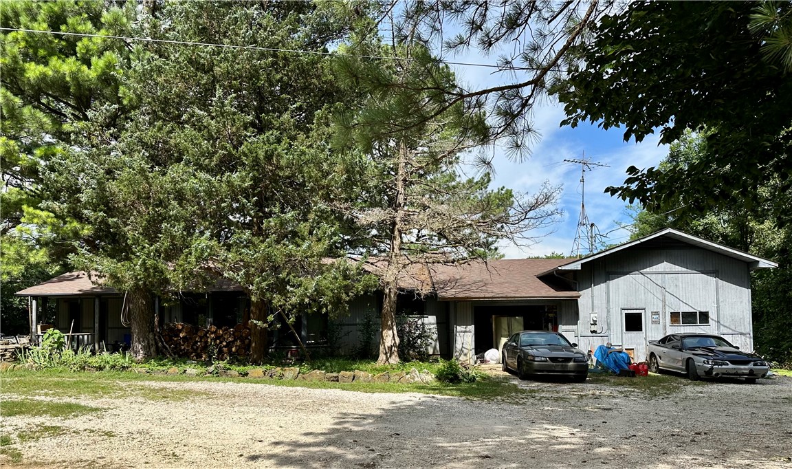 Live Near Devils Den State Park! Welcome to your own slice of tranquil living & country charm! This 3BR/2BA - 1,808 SF home is nestled on approximately 2.05 serene Acres along scenic HWY 170. Surrounded by mature trees, blooming plants, & a peaceful atmosphere, this property offers the perfect blend of privacy & convenience. Inside, you'll love the warmth of the stunning wood ceiling in the main living area & the natural light that pours through the bay window in the eat-in kitchen. The spacious primary suite features a large, jetted tub perfectly positioned beneath picture windows, providing relaxing views of the tranquil backyard. Outside, enjoy a garden spot ready for planting, multiple outbuildings including a charming chicken coop, & an RV pad w/electric & water hookupāideal for visitors or your own adventures. The attached garage & shop provide abundant storage & workspace. Whether you're looking for a homestead, a weekend escape, or a peaceful full-time residence, this property offers it all!