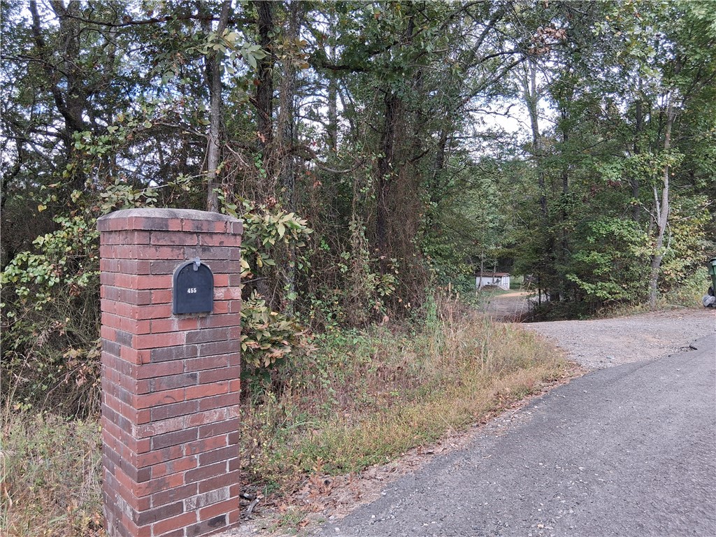 Private doublewide manufactured home with a permanent brick foundation. It has 4 bedrooms, 2 baths and above ground pool. A 520 SQ detached garage with brick and vinyl and metal roof, as well as dog fence, and a creek on the property. This property sold as is, and it is a SHORT SALE!