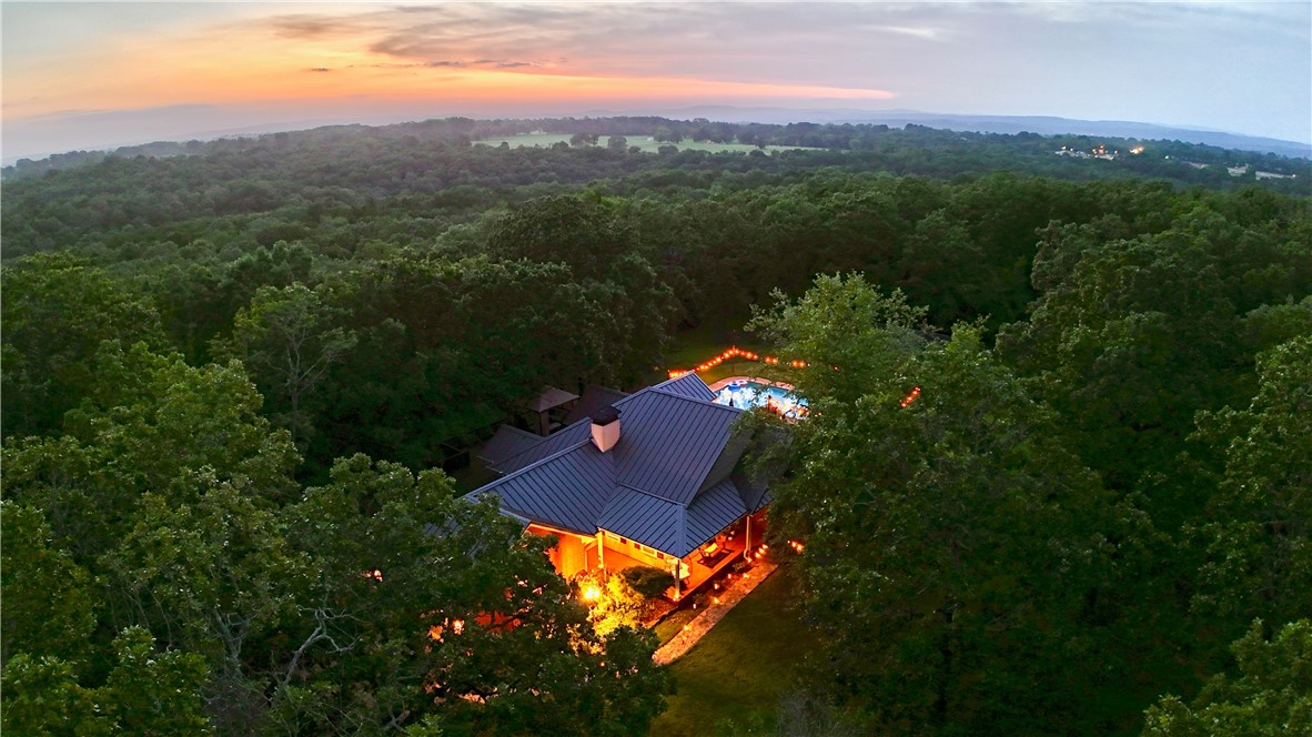 This hidden gem is the perfect residence for those seeking a private oasis. Pulling into the long driveway, you are greeted by lush trees and open acreage with a duck pond. The home boasts 4 bedrooms (or 3+ bonus room), 2 full baths, a living room with vaulted ceilings and a dining room that opens up to an expansive kitchen with a wet bar and nook overlooking the back deck. Large windows throughout provide serine views of the surrounding landscape, while allowing natural light to illuminate the home. This backyard paradise includes a salt water pool, stone fountain, pump house, multi-level deck, gazebo, outdoor speakers and ambient lighting. Inside, new flooring runs throughout the home with luxury vinyl plank in the main living areas, carpet in the bedrooms and a chic ledgestone stairwell leading to the second floor. The primary bedroom is equipped with a large walk-in closet, private bathroom with double vanity, oversized spa tub, walk-in shower and provides access to the deck. The home includes a solar panels.