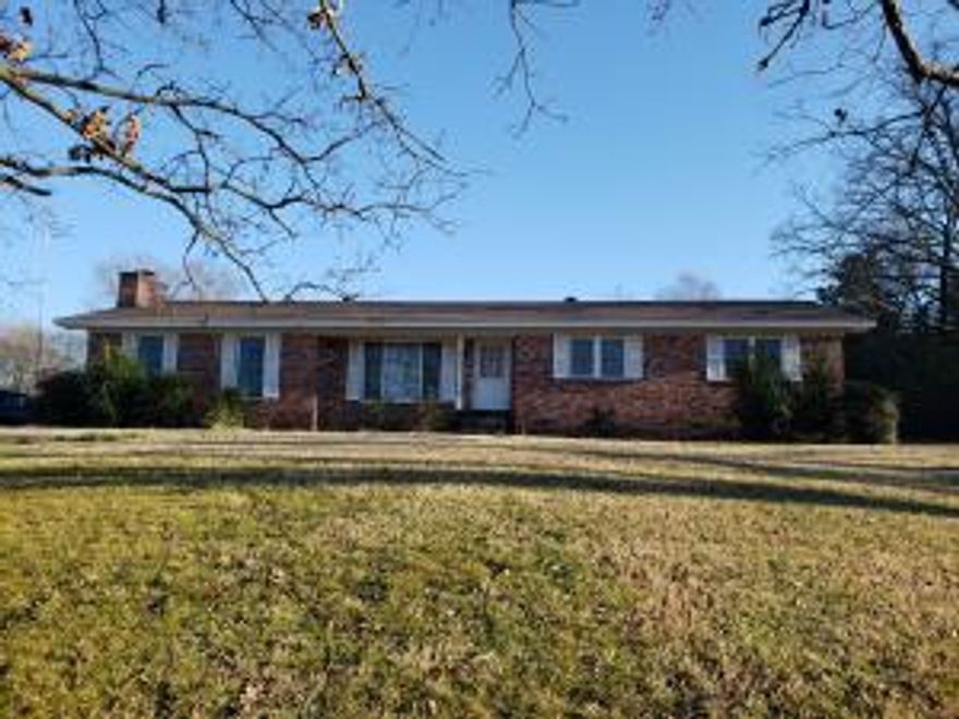 Hilltop setting with a spacious home. 3 bedroom 2.5 bathrooms and 2 living areas, one complete with a fireplace. Storage / workshop off of the 2 car carport and an additional storage building. 2.98 acres to enjoy and use.