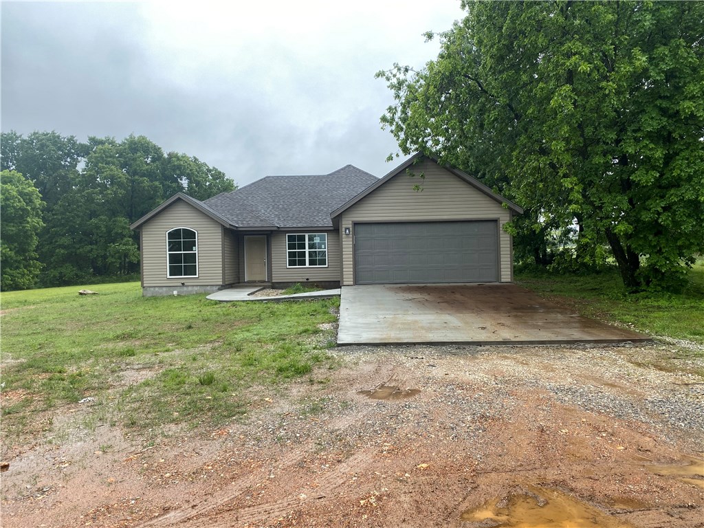 Beautiful 1 acre lot with new construction 4 bedroom home. Granite counter tops, covered patio and more. City water and city sewer while living outside the city limits. Build your metal shop or bring your camper and relax.